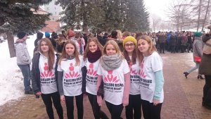 na placu unii europejskiej w mrągowie, grupka dziewczyn z koszulkami z napisem akcji, z tyłu tłum młodzieży