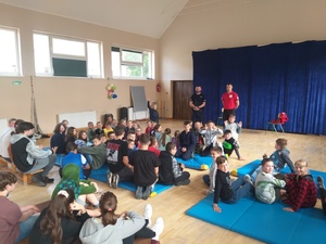 siedzące dzieci i stojący policjant i ratownik