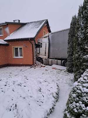 z lewej strony budynek mieszkalny a w niego wbity samochód ciężarowy