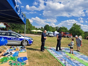 policjanci grają w grę plenerową z dziećmi