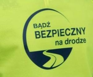 odblask i napis Bądź bezpieczny na drodze