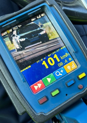 zdjęcie z laserowego miernika prędkości z prędkością 101 km/h i na wyświetlaczu miernika czarny pojazd BMW