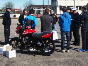 policjanci i uczestnicy przy motorowerze